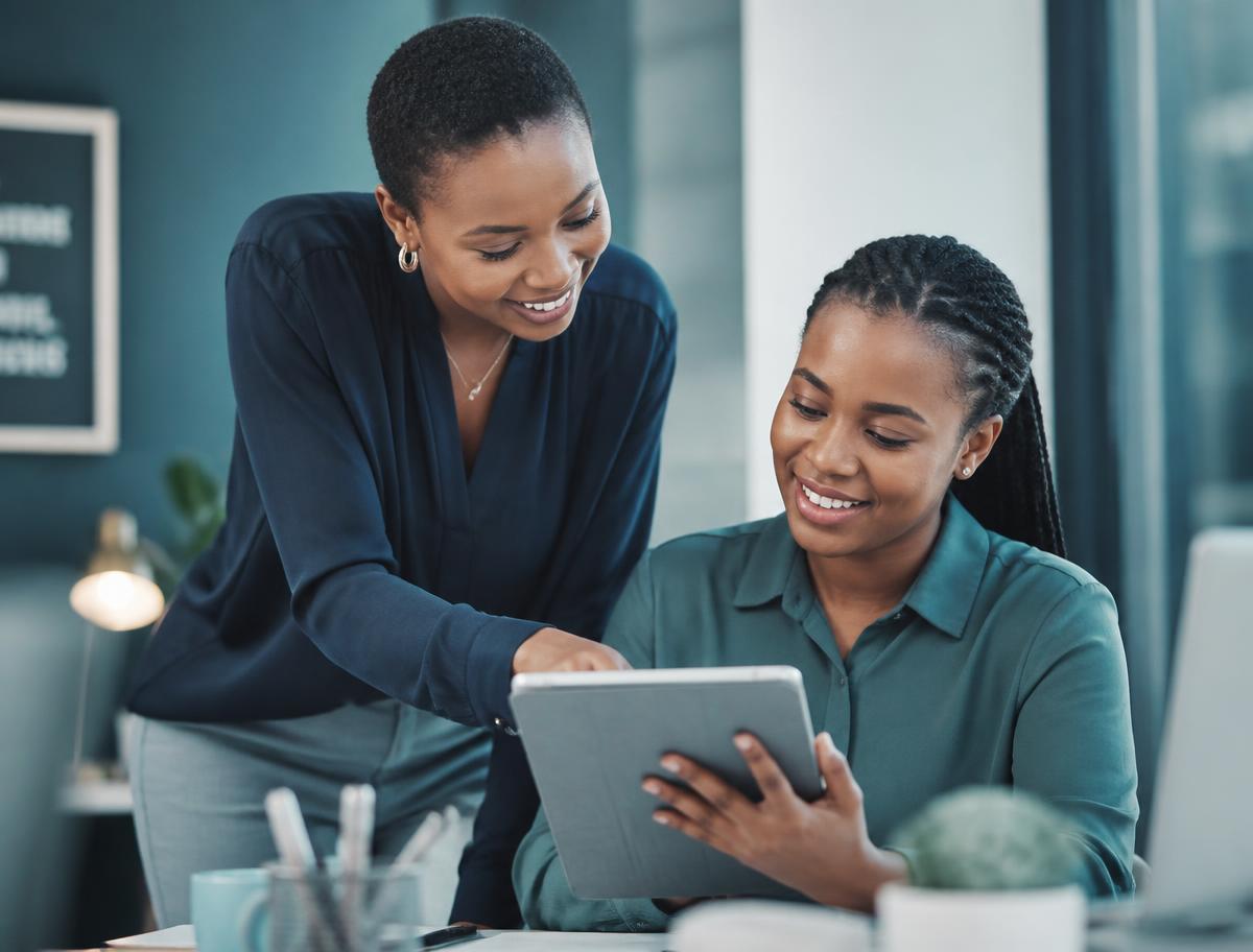 A mentor reviewing work with a junior professional